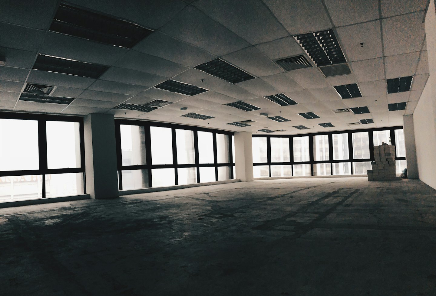 Empty commercial office space with concrete floor and construction blocks.
